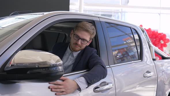 Auto Business, Consumer Guy Relish New Car and Shows Keys Sitting in Salon and Peeking Through