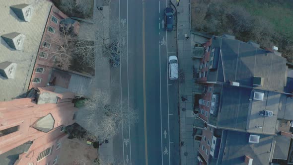 Aerial Top Down Drone Shot Flying Parallel to Quiet Road in Suburban Boston