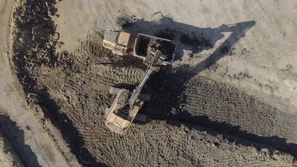 Digger Filling a Lorry With Soil and Mud During Groundworks