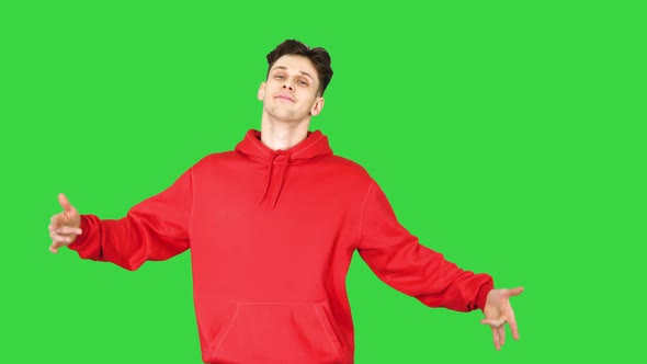 Casual Man in Red Hoody Dancing on a Green Screen, Chroma Key.