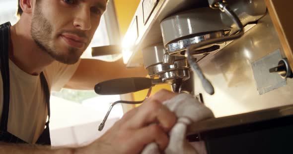 Male waiter cleaning coffeemaker machine 4k