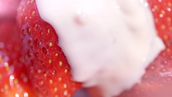 Extreme Closeup Flowing White Thick Yoghurt or Cream Pouring to Fresh Big Strawberry Slow Motion