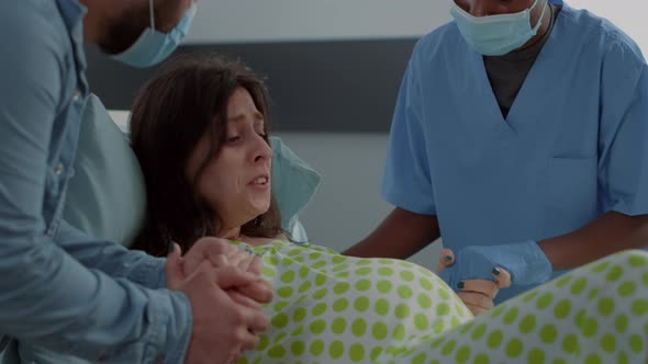 Caucasian Woman Giving Birth to Child in Hospital Ward
