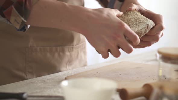 The Baker Breaks The Bread To Check The Readiness.