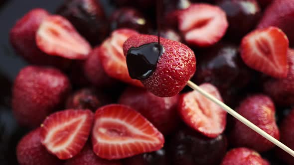 CloseUp of Sweet Dessert with Fresh Red Strawberry and Molten Chocolate Glaze