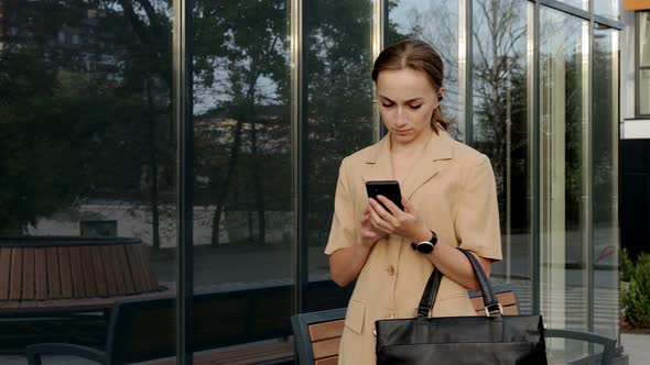 Adult Caucasian Confident Young Business Woman is Talking on Phone