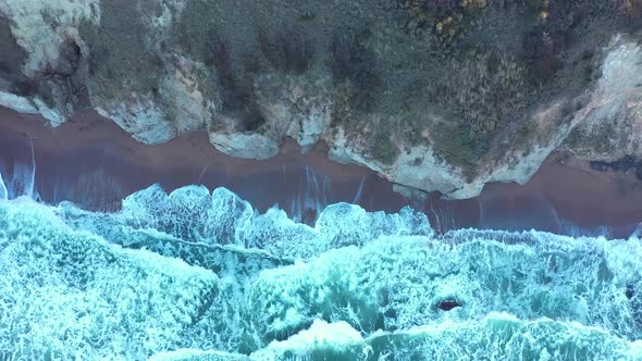 Aerial view to a beautiful wild rocky beach and big waves