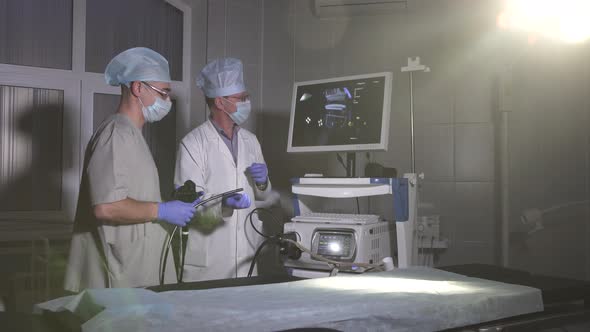 Doctor and Assistant Doctor Prepare Medical Equipment for Work