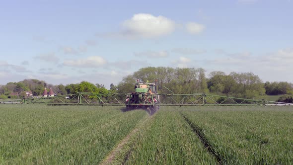 Tractor Spraying a Controversial Glyphosate Herbicide on Agricultural Land