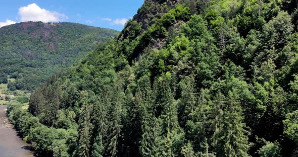 View Of Aries River And Forested Apuseni Mountain With Wooden Cross On Top In Transylvania, Romania.