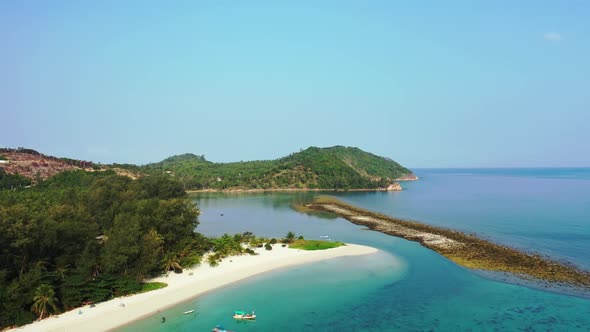 Aerial drone view scenery of tropical resort beach journey by blue green lagoon and white sandy back