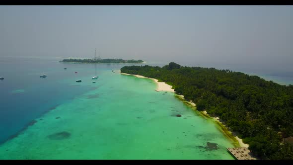 Aerial top view panorama of tropical seashore beach trip by shallow sea with white sandy background 