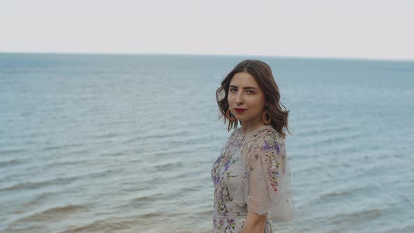 Portrait of Attractive Woman with Red Lips and Curly Hair Looking at Camera Medium Shot Slow Motion