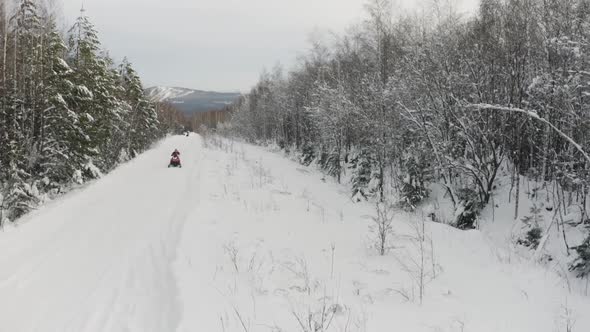 Male riding snowmobile, moving fast towards camera