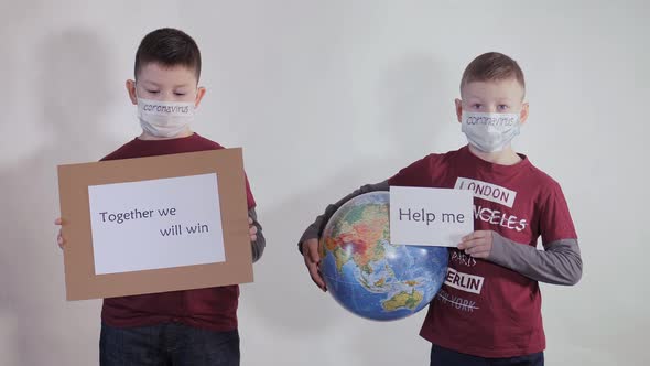 Boy Holds a Globe, a Model of the Planet Earth, Child Is Holding a Sign with the Inscription: HELP