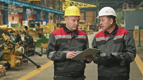 Portrait Of Male Plant Workers Talking