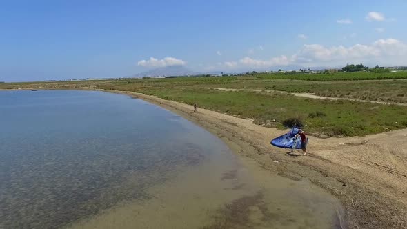 Aerial drone view of a man kiteboarding on a kite board