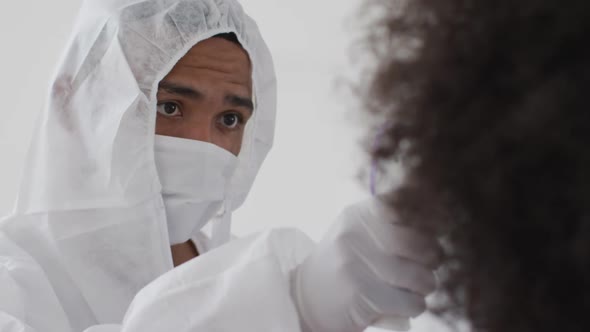 Male health worker measuring temperature with temperature gun