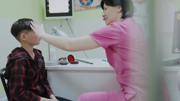 Doctor Checking and Examination on Eye with Little Boy Child in Hospital