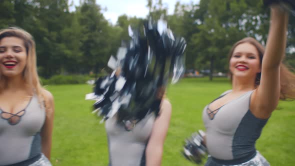 Portrait of Dancing Cheer Team in Uniform in Summer Park