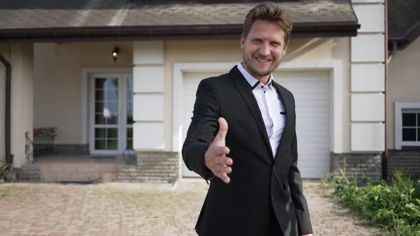 Smiling Professional Real Estate Agent Gesturing Hello Stretching Hand Smiling Looking at Camera