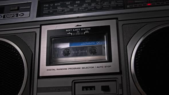 Audio Cassette Tape Rotates in Deck of an Old Tape Recorder