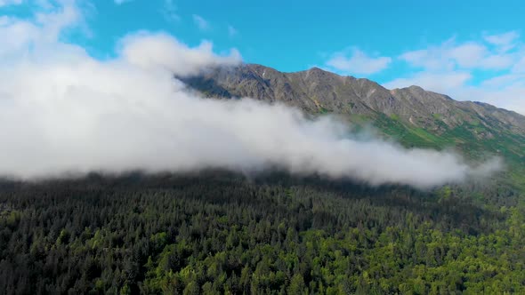 4K Drone Video of Low Elevation Clouds Racing Across Steep Grassy Mountain on Shore of Turnagain Arm