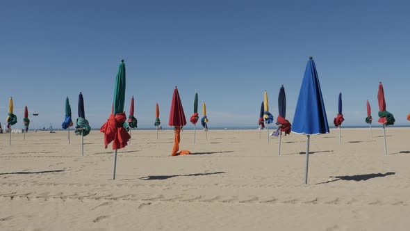 DEAUVILLE, FRANCE - SEPTEMBER 2016 Beautiful  colorful parasols in a row of famous film festival cit