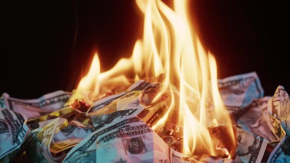 Burning of American 50 Dollar Banknotes on Black Background