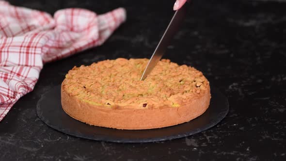 The Girl Cuts Delicious Cherry Cake with Shortcrust Pastry