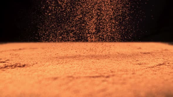 Super Slow Motion Cocoa Powder is Poured on the Table