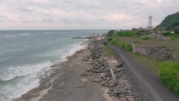 Aerial Footage of Pandawa Beach Embankment with Waves Crashing on Reef Unknown Silhouettes of