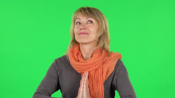 Portrait of Middle Aged Blonde Woman Is Daydreaming and Smiling Looking Up. Green Screen