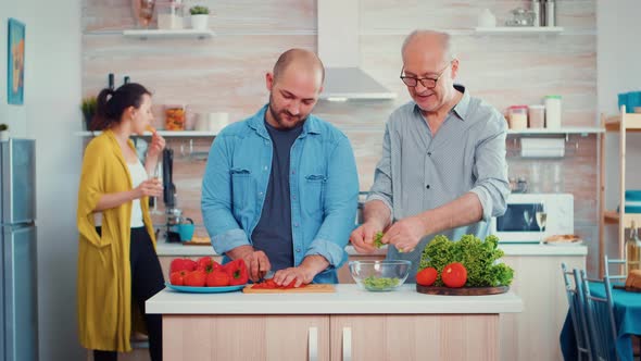 Grandfather and Son Preparing a Salad