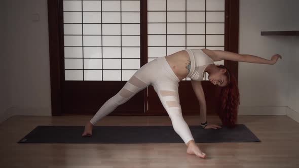 Attractive Woman Practicing Yoga in the Morning