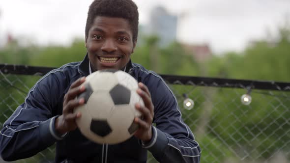 African Man Looking at Camera and Cheering for Soccer Team