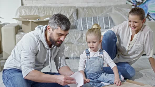 Family Unpacking Wooden Furniture alt