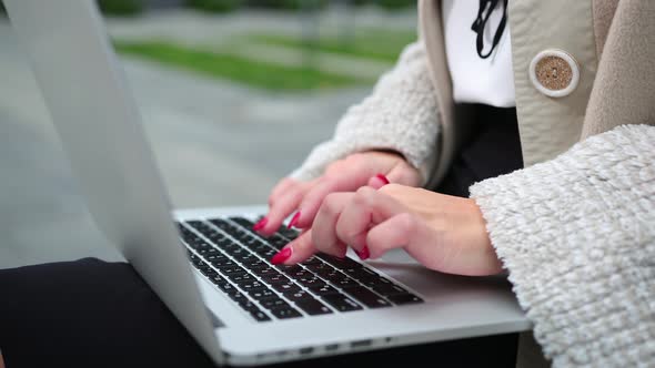 Female fingers pressing a keys on contemporary laptop. Working the computer.