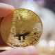Man Holding in Hand Symbol of Crypto Bitcoin Coin - VideoHive Item for Sale