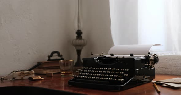 Workplace with an old typewriter next to the window