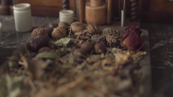 Camera Moving Up Showing Dried Flowers, Nuts and Retro Style Test Tubes. Ancient Chemical