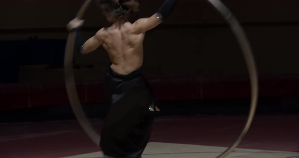 Training Session of Wheel Gymnastics Muscular Man Is Spinning in a Hoop