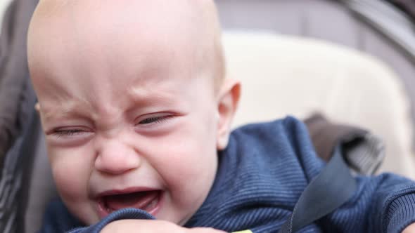 Crying Baby Infant Portrait Opened Mouth Teeth Outdoors in Carriage Fussy Kid