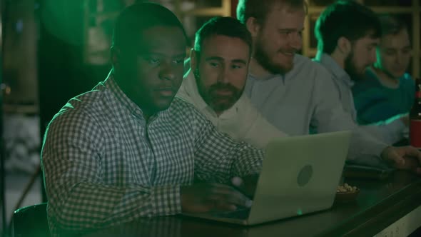 African-American using laptop in pub