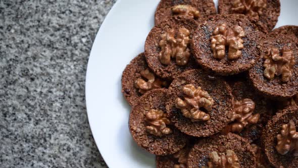 Healthy Cookies Made Of Bitter Cocoa And Seeds Top With Walnut In A Plate. Top, Slide Shot