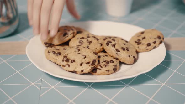 Hands Take Fresh Cookies From Plate Closeup