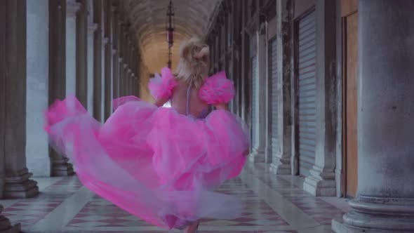 Girl with Pink Dress Runs in Slow Motion Under Venetian Arcades