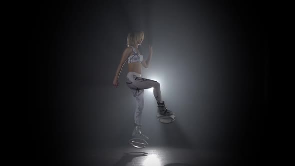 Athletic Girl in Sports Suit Dancing in Kangoo Jumps Shoes