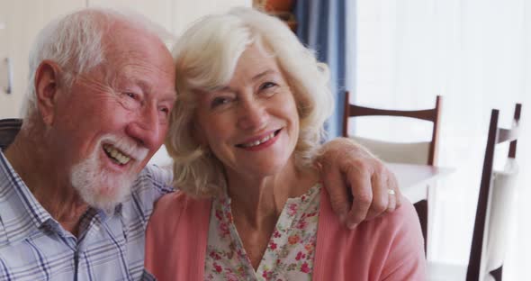 Senior couple in social distancing smiling at camera