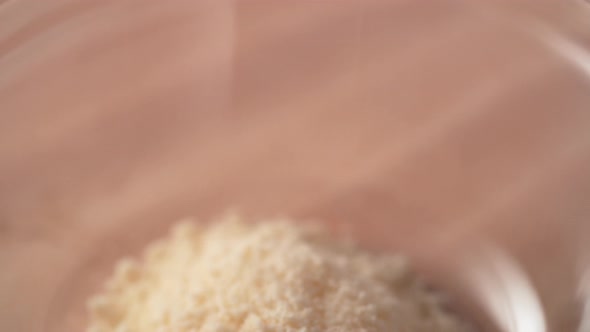 Camera follows adding eggs into bread crumb in a bowl. Slow Motion.